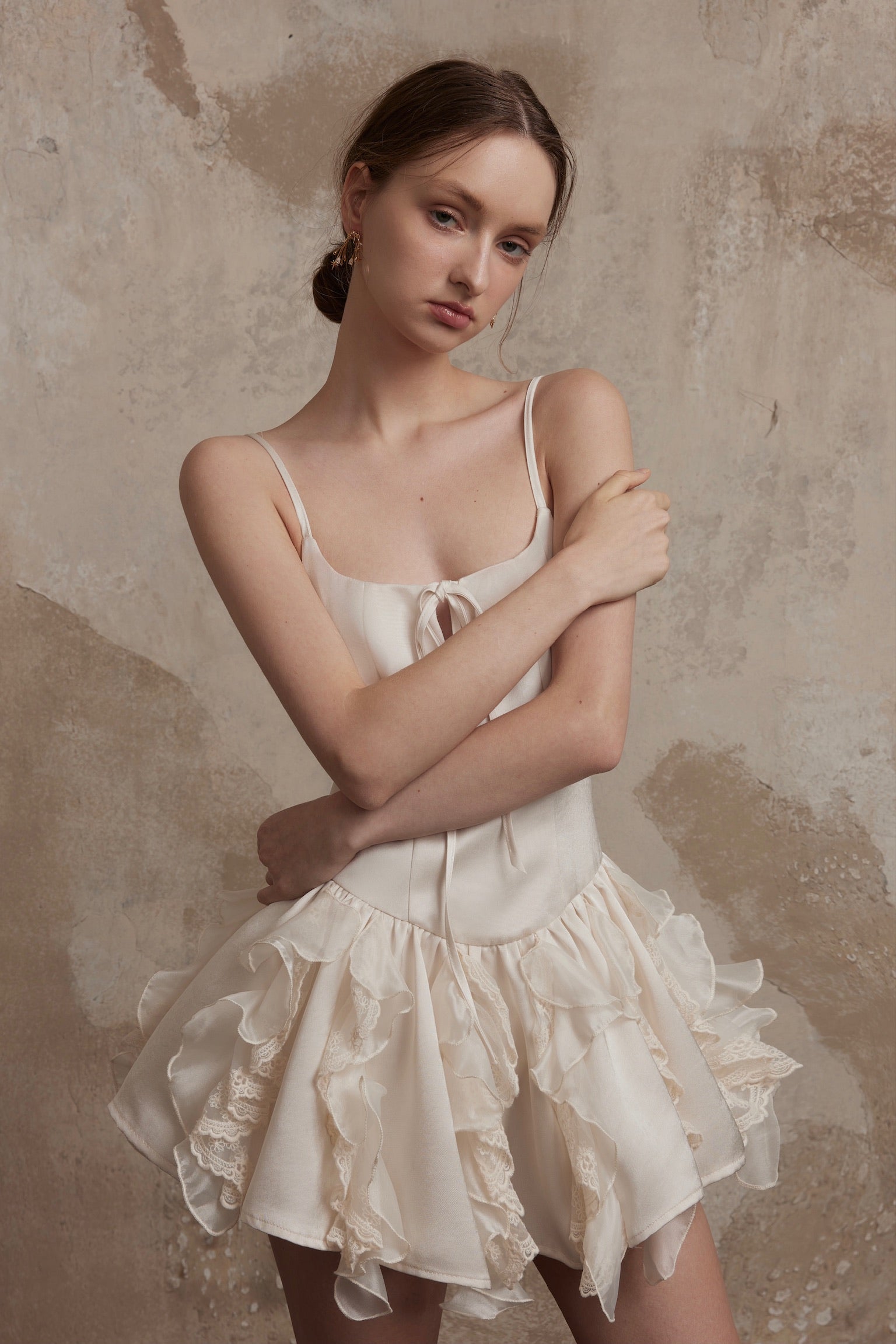 Nuvola Mousse Sun Dress in ivory with ruffled tulle layers and satin finish, featuring a fitted bodice and flared hem for airy elegance.