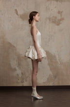 Side profile of Nuvola Mousse Sun Dress showing sculpted bodice and dimensional ruffle hem, perfect for ethereal summer looks.