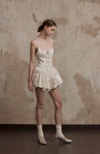 Nuvola Mousse Sun Dress in soft ivory with satin and tulle layers, styled with metallic heels for a whimsical, romantic outfit.