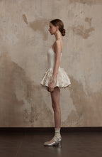 Side view of Nuvola Mousse Sun Dress highlighting its airy construction and fluttering hem, ideal for warm-weather elegance.