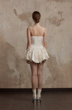 Back view of Nuvola Mousse Sun Dress showcasing delicate satin straps and layered ruffle skirt, ideal for romantic summer styling.